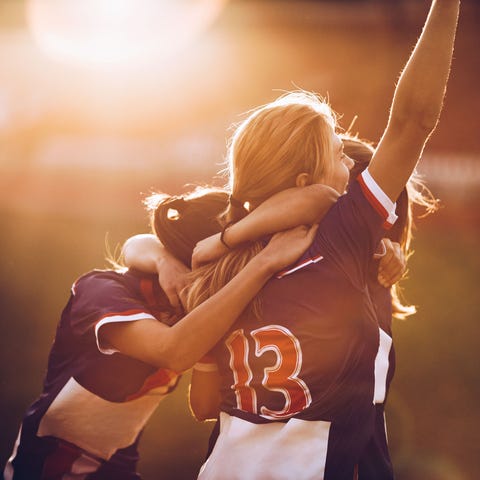 Team of happy female soccer players celebrating...