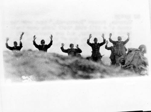 German troops surrender to US soldiers during the Allied Invasion of Europe, D-Day, in Normandy, France on June 6, 1944.