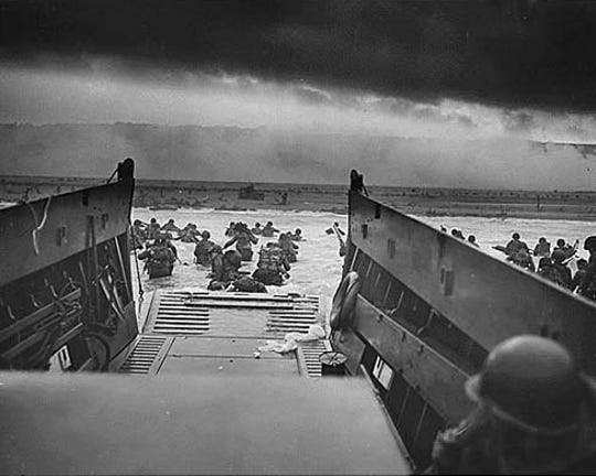 US soldiers wade through surf and German gunfire to secure a beachhead during the Allied Invasion, on the beaches of Normandy.