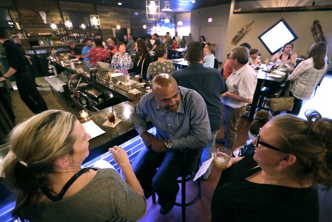 Jacqueline Wynn, left, Larry Wynn and Abby Williams, right, enjoy cocktails during a "friends and family" test night Tuesday at Savor Food and Spirits in Kimberly.