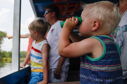 Cal Lounsbury, 1, looks for wildlife through his binoculars while on a historic boat tour at Wakulla Springs State Park Monday, June 3, 2019. 