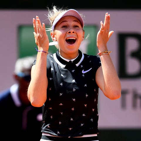 American Amanda Anisimova celebrates victory...