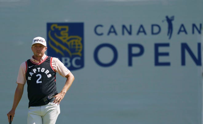 Canadian Mackenzie Hughes, wearing a Toronto Raptors Kawhi Leonard jersey, waits to putt on the 13th hole during the first round of the Canadian Open.
