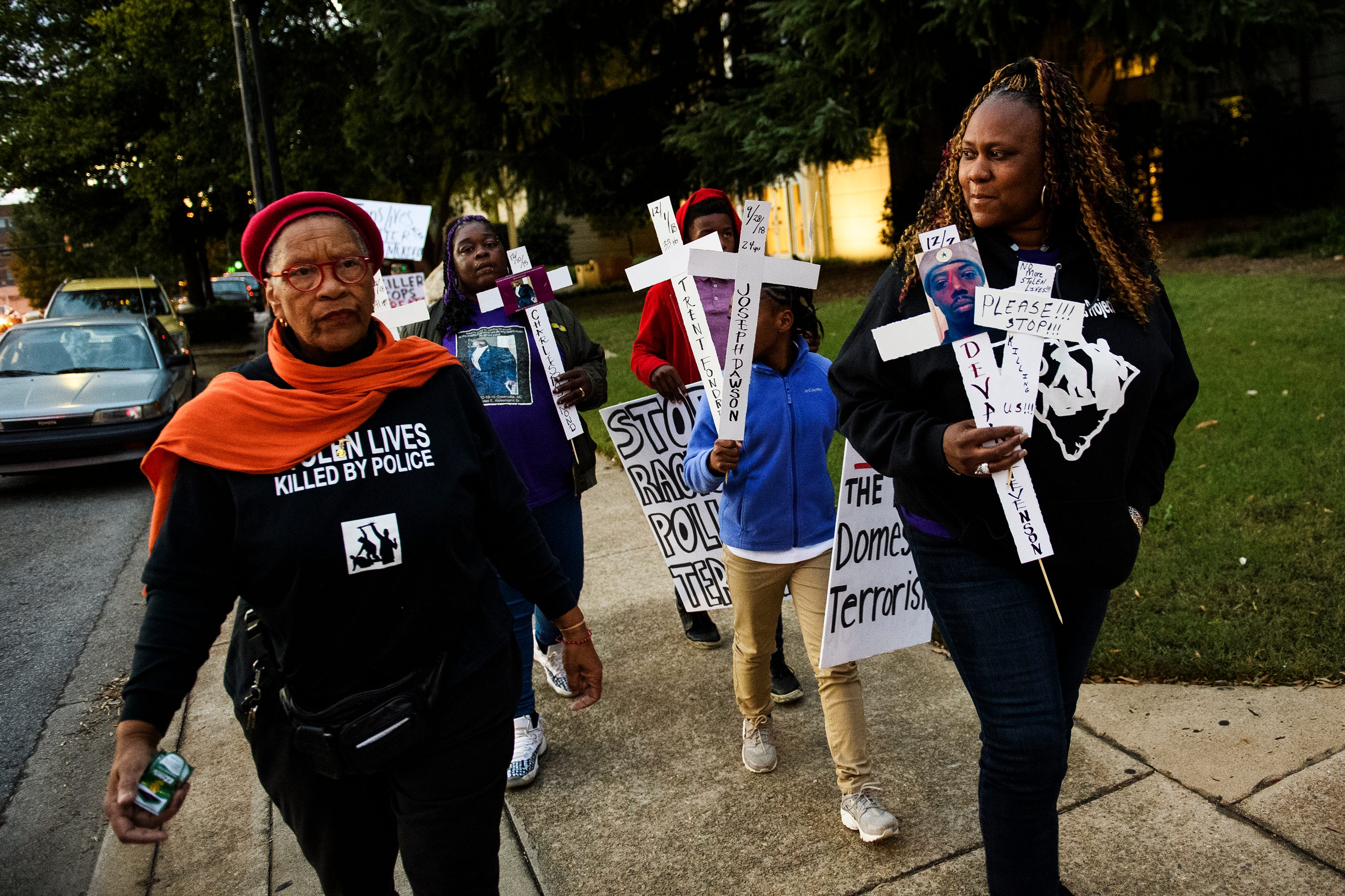 Efia Nwangaza, left, and Candace Brewer march during a protest against police brutality in downtown Greenville Monday, Oct. 22, 2018. 