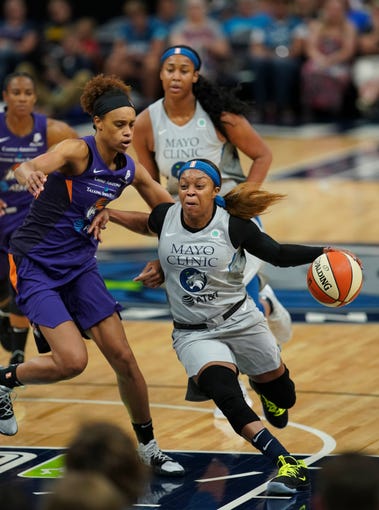 Minnesota Lynx guard Odyssey Sims drives around Phoenix Mercury forward Brianna Turner during the first quarter of a WNBA basketball game Thursday, June 6, 2019, in Minneapolis.