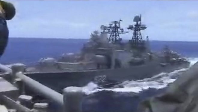 In this image from video provided by the U.S. Navy, a Russian destroyer, left, sails very close to the USS Chancellorsville, right, while operating in the Philippine Sea, Friday, June 7, 2019. The U.S. and Russian militaries accused each other of unsafe actions in the incident. (Photo by Petty Officer 1st Class Christopher J Krucke)