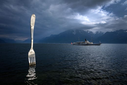 The paddle steamer 'Italie' sails on Lake Geneva past a giant fork sculpture designed by Switzerland's artist Jean-Pierre Zaugg, May 21, 2019. 