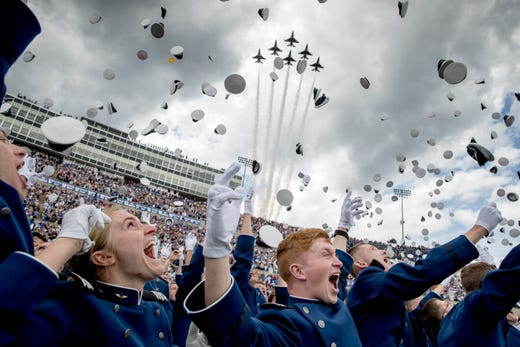 United States Air Force Academy cadets toss their hats in the air as the Thunderbirds fly overhead during the cadets' graduation ceremony at Falcon Stadium., May 30, 2019, in Colorado Springs, Colo. 