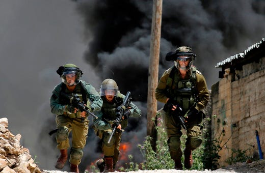 Israeli security forces take position during clashes with Palestinian stone throwers following a weekly demonstration against the expropriation of Palestinian lands by Israel, in the village of Kfar Qaddum, near Nablus in the occupied West Bank, on May 3, 2019.