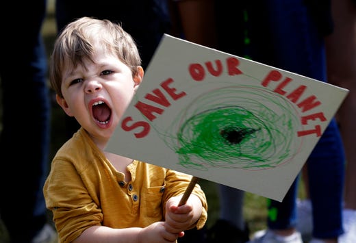 A young protestor takes part in a demonstration organized by 'Global Strike 4 Climate' in Parliament Square in London, May 24, 2019.