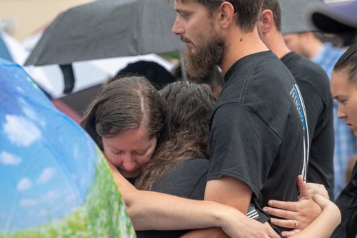Members of the community are overcome by emotion at a vigil in Virginia Beach, Va. on June 1, 2019. Virginia Beach officials said 11 city employees and one private contractor were killed during Friday's shooting rampage along with the suspected shooter, city engineer DeWayne Craddock.