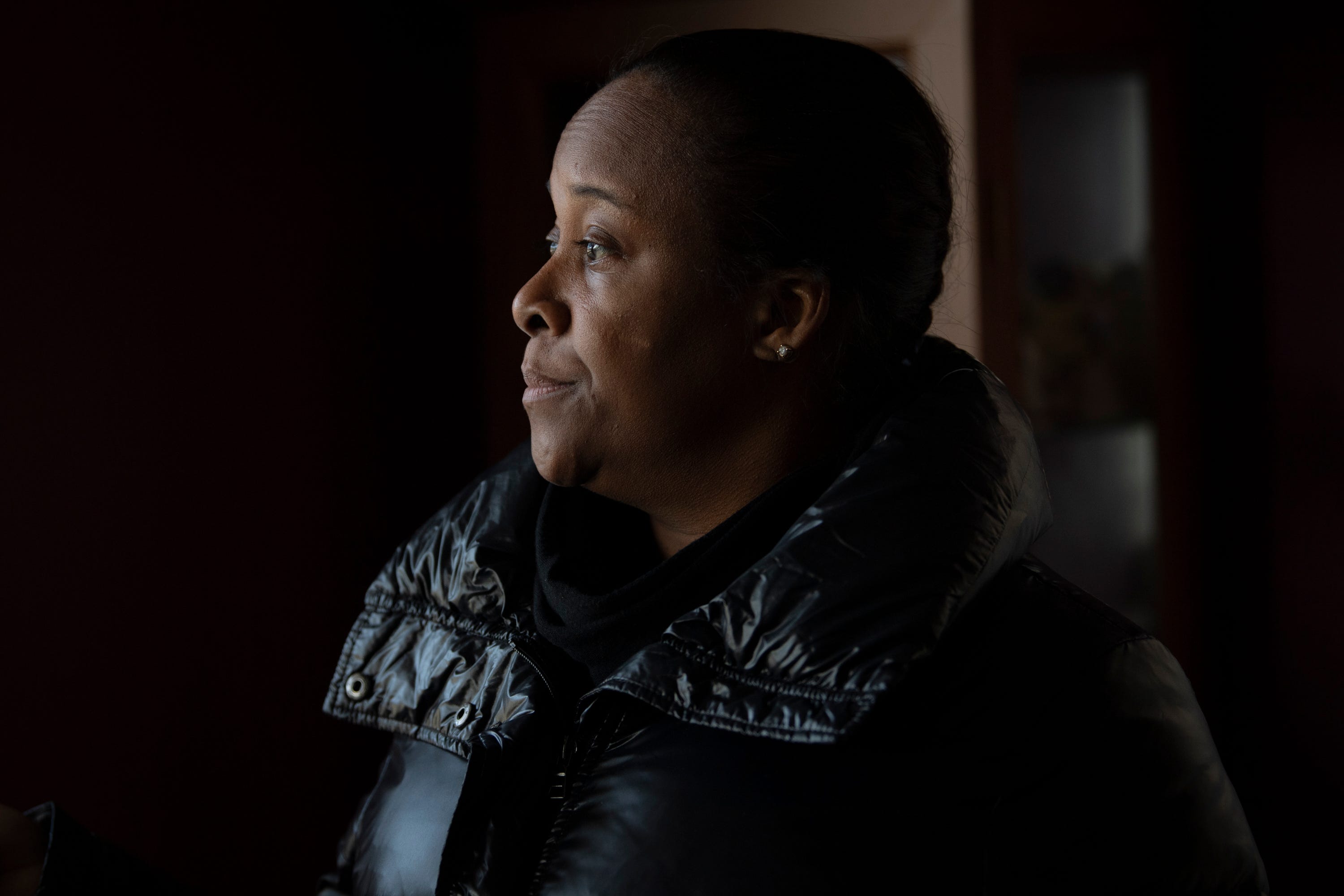 Lori Frazier pauses to reflect for moment while looking through her parents' home. After Frazier’s father passed away, she and her family were surprised to discover that her parents had taken out a reverse mortgage on their home. She had hoped to move into the house with her son, Amari, after her parents died, but cannot afford to pay off the large reverse mortgage.