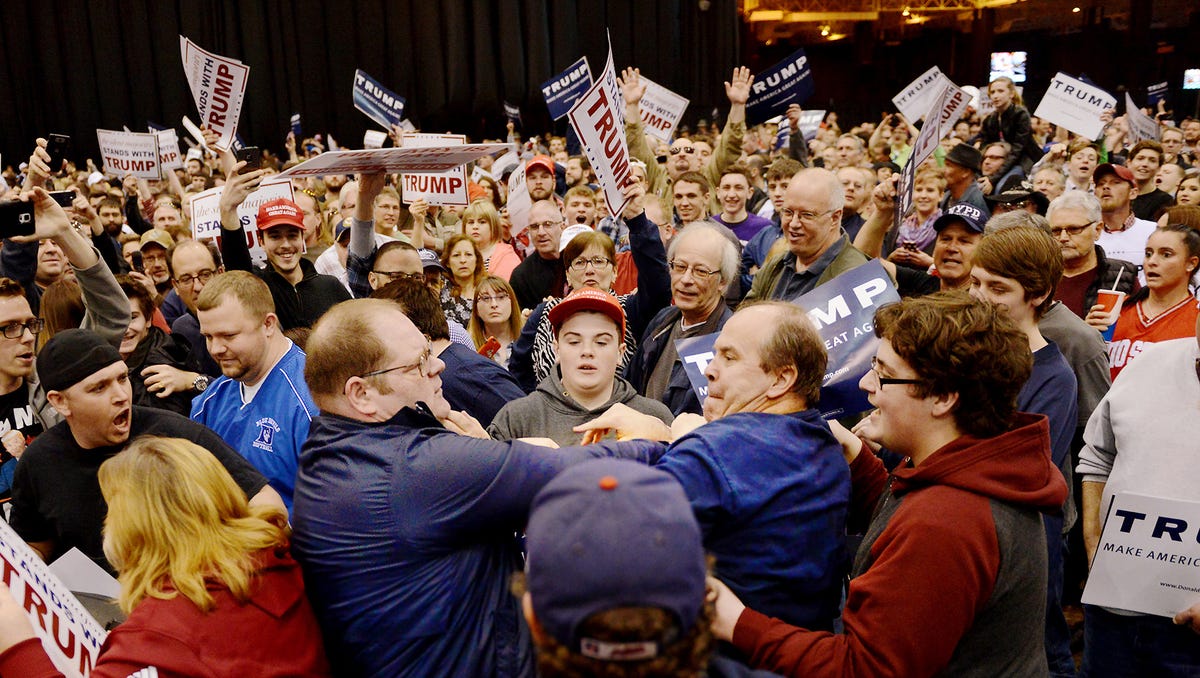 A protester and Trump supporter scuffle during a rally for then-presidential candidate Donald Trump on Saturday, March, 12, 2016, at I-X Arena in Cleveland, Ohio.