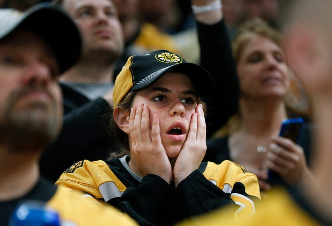 Boston Bruins fans watch the closing minutes of Game 5.