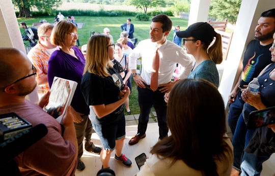 Democratic presidential candidate Pete Buttigieg, center, speaks to local residents during a house party, Friday, June 7, 2019, in Winterset, Iowa.