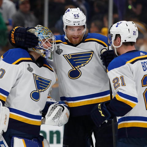 Blues players celebrate after the win in Game 5.