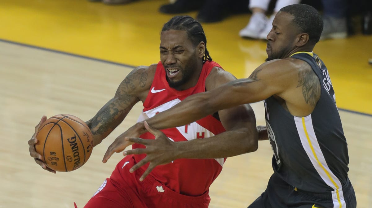 Kawhi Leonard drives to the basket while Andre Iguodala defends during the first quarter of Game 4 of the NBA Finals.