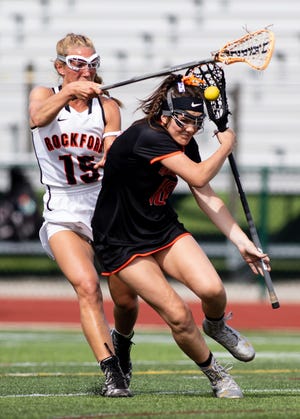 Brighton's Sophie Mondro, who scored four goals, is defended by Rockford's Anna Glynn during the state Division 1 lacrosse championship game at Novi on Saturday, June 8, 2019.