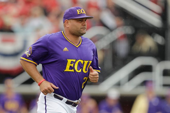 East Carolina head coach Cliff Godwin runs to question a call during the fourth inning in Game 1 of an NCAA college baseball super regional tournament against Louisville, Friday, June 7, 2019, in Louisville, Ky. (AP Photo/Darron Cummings)