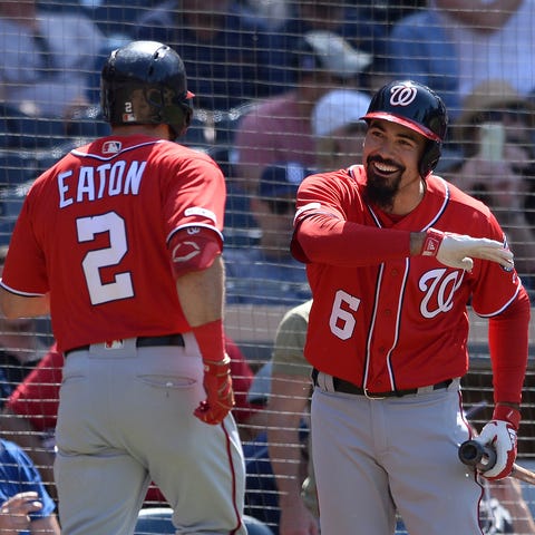 Adam Eaton is congratulated by Anthony Rendon...