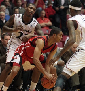 Jacksonville State Gamecocks guard Dion Waiters (1) is surrounded by Cincinnati Bearcats players Sean Kilpatrick and Octavius Ellis in 2011.