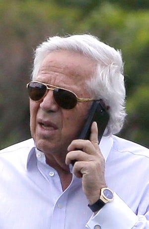 New England Patriots owner Robert Kraft speaks on a phone during an NFL football minicamp practice.