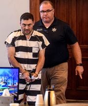 Oxford Police Officer Matthew Kinne, center, is escorted into a hearing by Lafayette County Sheriff Dept. Maj. Alan Wilburn at the Lafayette County Courthouse, Wednesday, May 22, 2019, in Oxford, Miss.