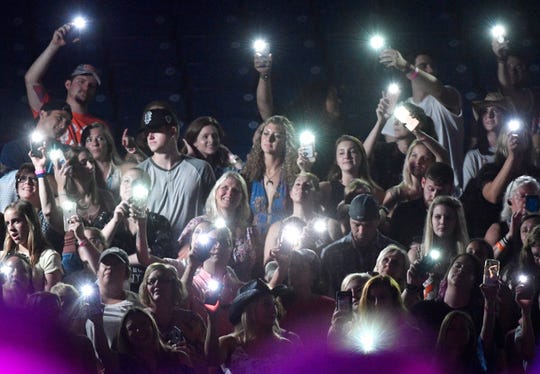 Fans listen to Chris Janson perform during the 2019 CMA Fest on June 9.