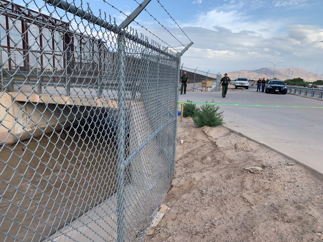 Police investigate the site where three bodies were found Monday morning, June 10, 2019, in a water tunnel near the U.S.-Mexico border in El Paso.