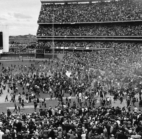 Fans engulf the field at Shea Stadium after the Me
