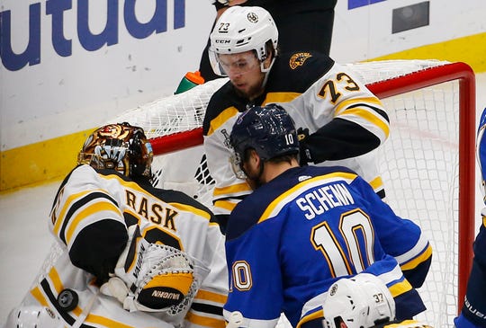The puck rolls down the back of Boston Bruins goaltender Tuukka Rask aftter defenseman Charlie McAvoy helped keep it out of the net.