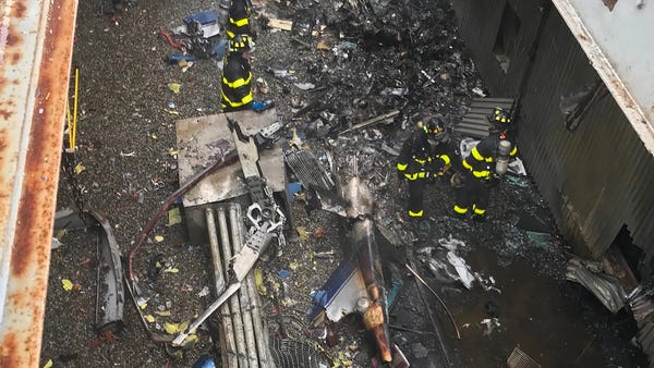 New York City firefighters work at the scene of a...