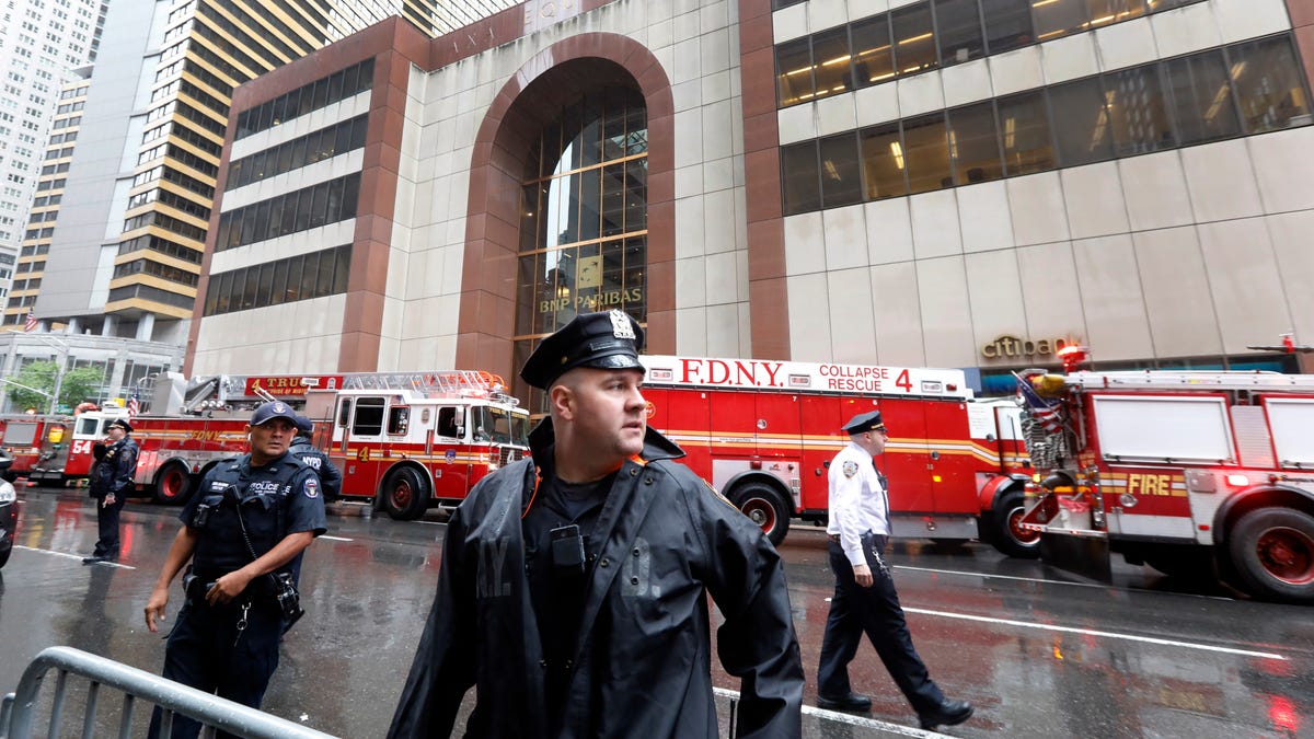 New York City Police and Fire Department personnel secure the scene in front of a building in midtown Manhattan where a helicopter crash landed,  June 10, 2019.