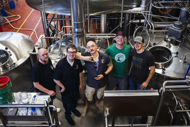 Jungle Jim's International Market workers, from left, Ferdinand Sneed and Eric Dunaway partnered with MadTree Brewing workers Sam Marts, Dan Shatto, and Ryan Johnston to prepare a limited-run beer, Everybody Gose to the Jungle, that will debut at Jungle Jim's International Craft Beer Festival in Fairfield  June 14-15.