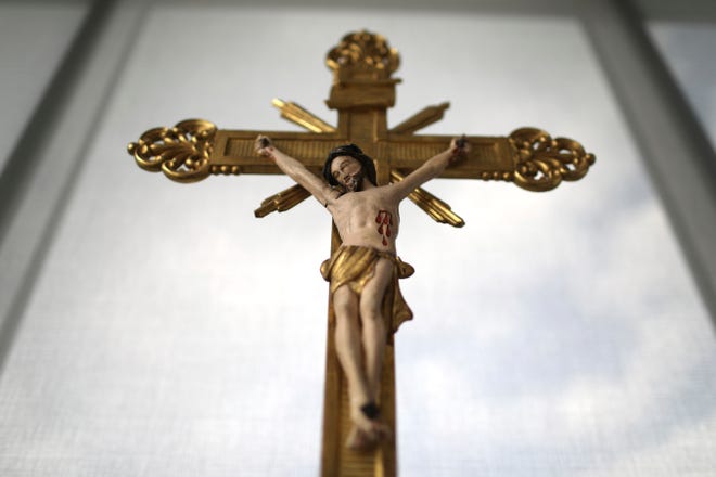 An antique crucifix is displayed the prayer room in the apartment of Laura Pontikes in Houston on April 13, 2019.