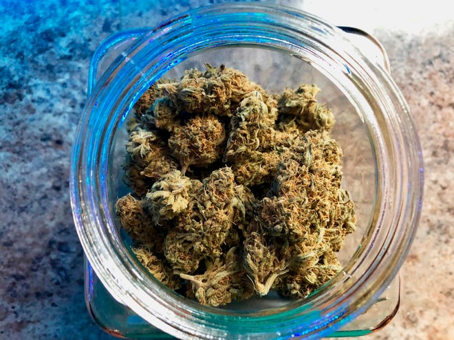 In this April 8, 2019, photo, a jar of medical marijuana sits on the counter at Western Oregon Dispensary in Sherwood, Ore.