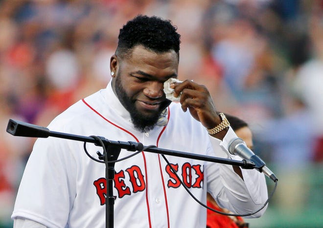 In this June 23, 2017, file photo, Boston Red Sox baseball great David Ortiz wipes a tear at Fenway Park in Boston as the team retires his number "34" worn when he led the franchise to three World Series titles. Ortiz was back in Boston for medical care after authorities said the former Red Sox slugger affectionately known as Big Papi was ambushed by a gunman at a bar in his native Dominican Republic.