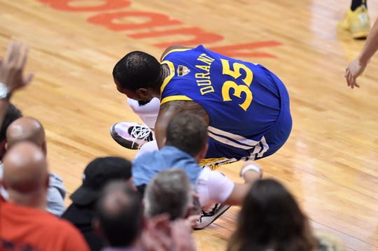 Golden State Warriors forward Kevin Durant (35) goes down with a leg injury against the Toronto Raptors during first half action in Game 5 of the NBA Finals in Toronto on Monday, June 10, 2019. (Frank Gunn/The Canadian Press via AP)
