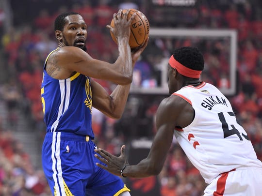 Golden State Warriors forward Kevin Durant, left, protects the ball from Toronto Raptors forward Pascal Siakam (43) during first-half basketball game action in Game 5 of the NBA Finals in Toronto, Monday, June 10, 2019. (Frank Gunn/The Canadian Press via AP)