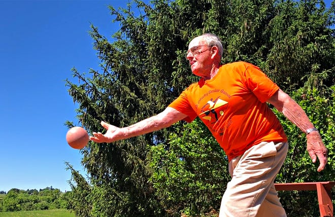 John Barton, 93, demonstrates how to play bocce on his bocce court in the back yard of his home in Stewartstown, Tuesday, June 11, 2019. Barton, who will be the torch-bearer for the 2019 opening ceremonies, has participated in the games since 2007. Dawn J. Sagert photo