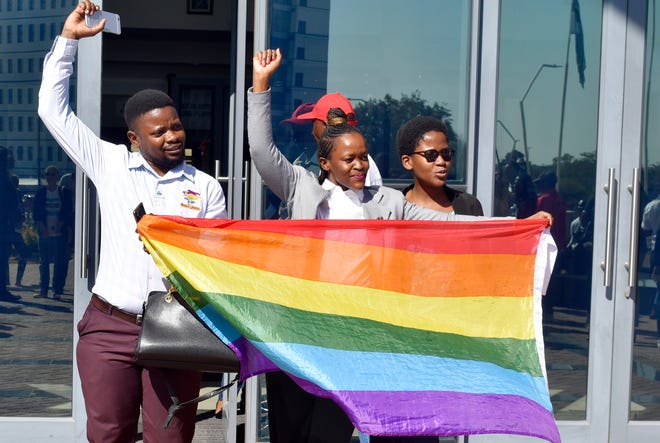 Activists celebrate outside the High Court in Gaborone, Botswana, Tuesday June 11, 2019.