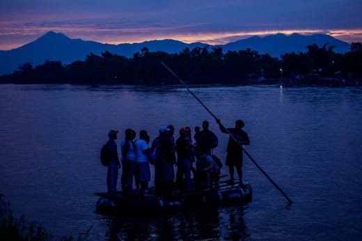 TOPSHOT - Central American migrants and locals arrive in Ciudad Hidalgo in Chiapas State, Mexico, after illegally crossing the Suchiate river from Tecun Uman in Guatemala in a makeshift raft, on June 10, 2019. - In the framework of Mexico's deal to curb migration in order to avert US President Donald Trump's threat of tariffs, Mexico's Foreign Minister Marcelo Ebrard said Mexico will discuss a "safe third country" agreement with the US -- in which migrants entering Mexican territory must apply for asylum there rather than in the US -- if the flow of undocumented immigrants continues. (Photo by Pedro PARDO / AFP) (Photo credit should read PEDRO PARDO/AFP/Getty Images) *** BESTPIX *** ORIG FILE ID: 1148932319.jpg