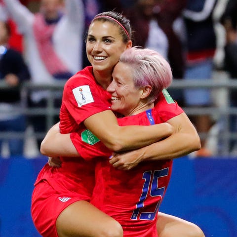 Alex Morgan, left, celebrates with Megan Rapinoe...