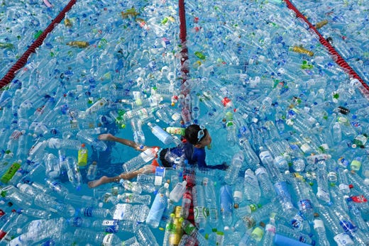 TOPSHOT - A child swims in a pool filled with plastic bottles during an awareness campaign to mark the World Oceans Day in Bangkok on June 8, 2019. (Photo by Romeo GACAD / AFP)ROMEO GACAD/AFP/Getty Images ORIG FILE ID: AFP_1HC8JX
