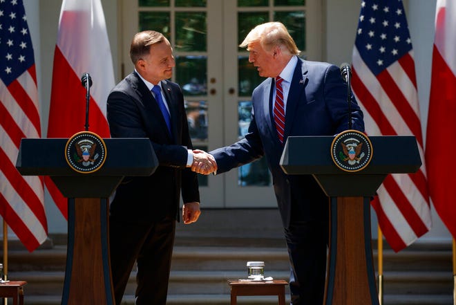 President Donald Trump shakes hands with Polish President Andrzej Duda during a news conference in the Rose Garden of the White House, Wednesday, June 12, 2019, in Washington.