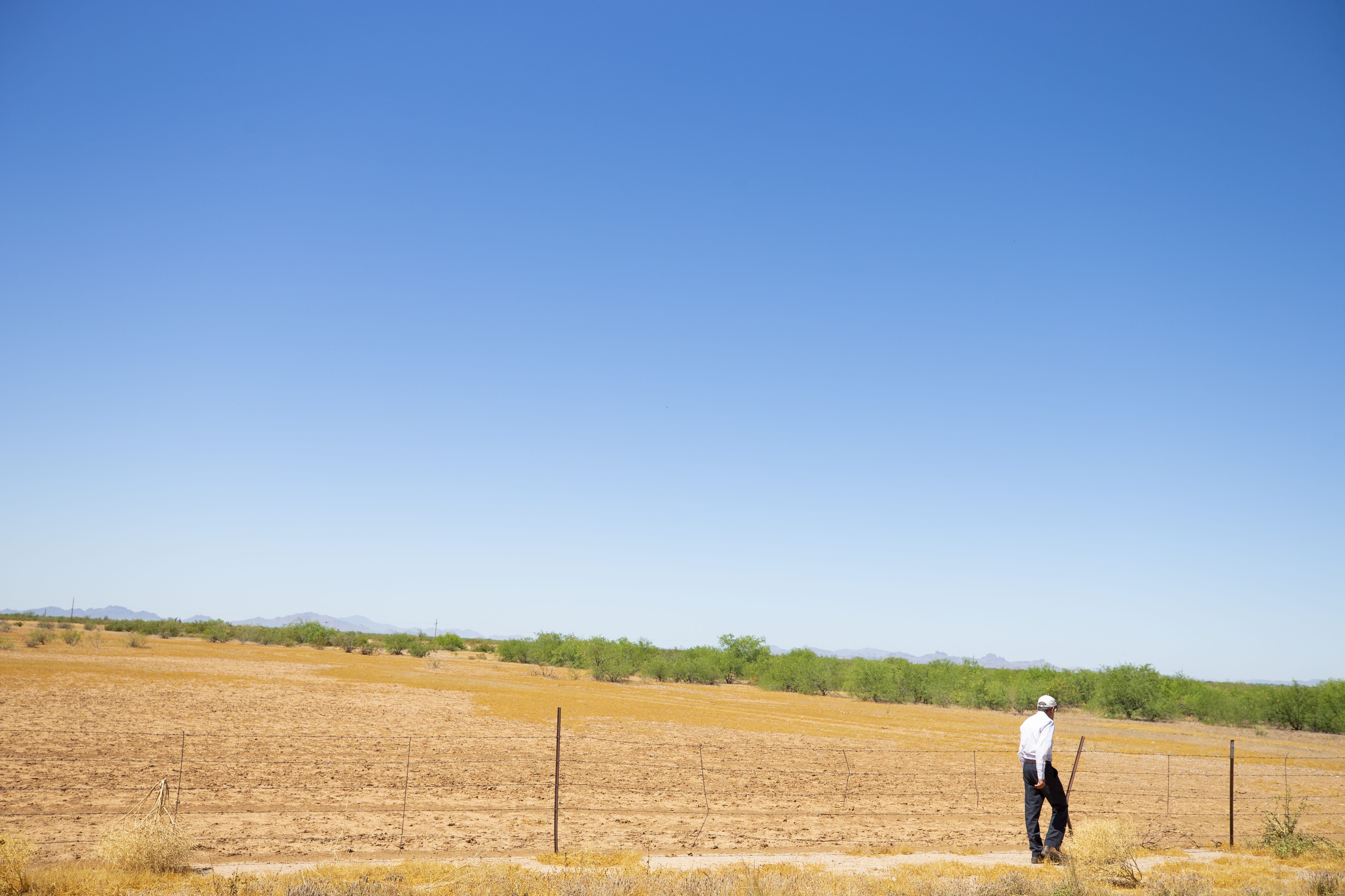 Peter Hyde, an Arizona State University adjunct research professor who studies the growing dangers of blowing dust, walks through a field in Pinal County. “The future is not bright for dust storms," Hyde says. "They're going to get worse and there are going to be more of them.”