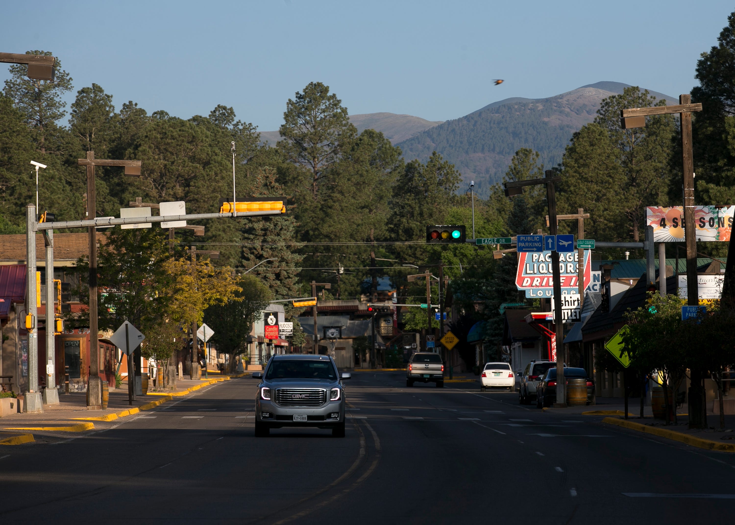 A vehicle drives through the main business strip in Ruidoso, New Mexico, on June 1, 2019.