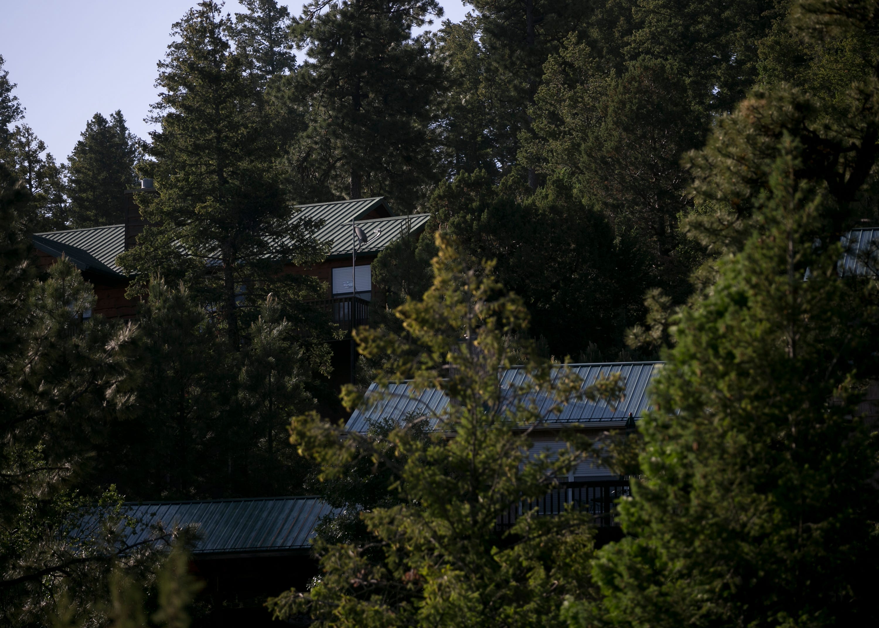 Homes are seen through the trees of Upper Canyon in Ruidoso, New Mexico, on June 1, 2019.