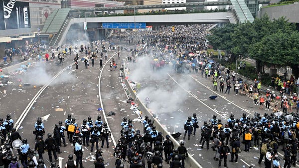 Protesters retreat  after police fired tear gas...