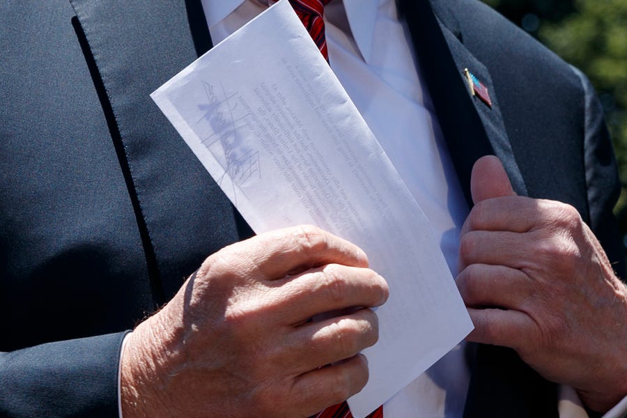 President Donald Trump holds a letter as he speaks to reporters before departing for a trip to Iowa, on the South Lawn of White House, Tuesday, June 11, 2019, in Washington. (AP Photo/Evan Vucci)